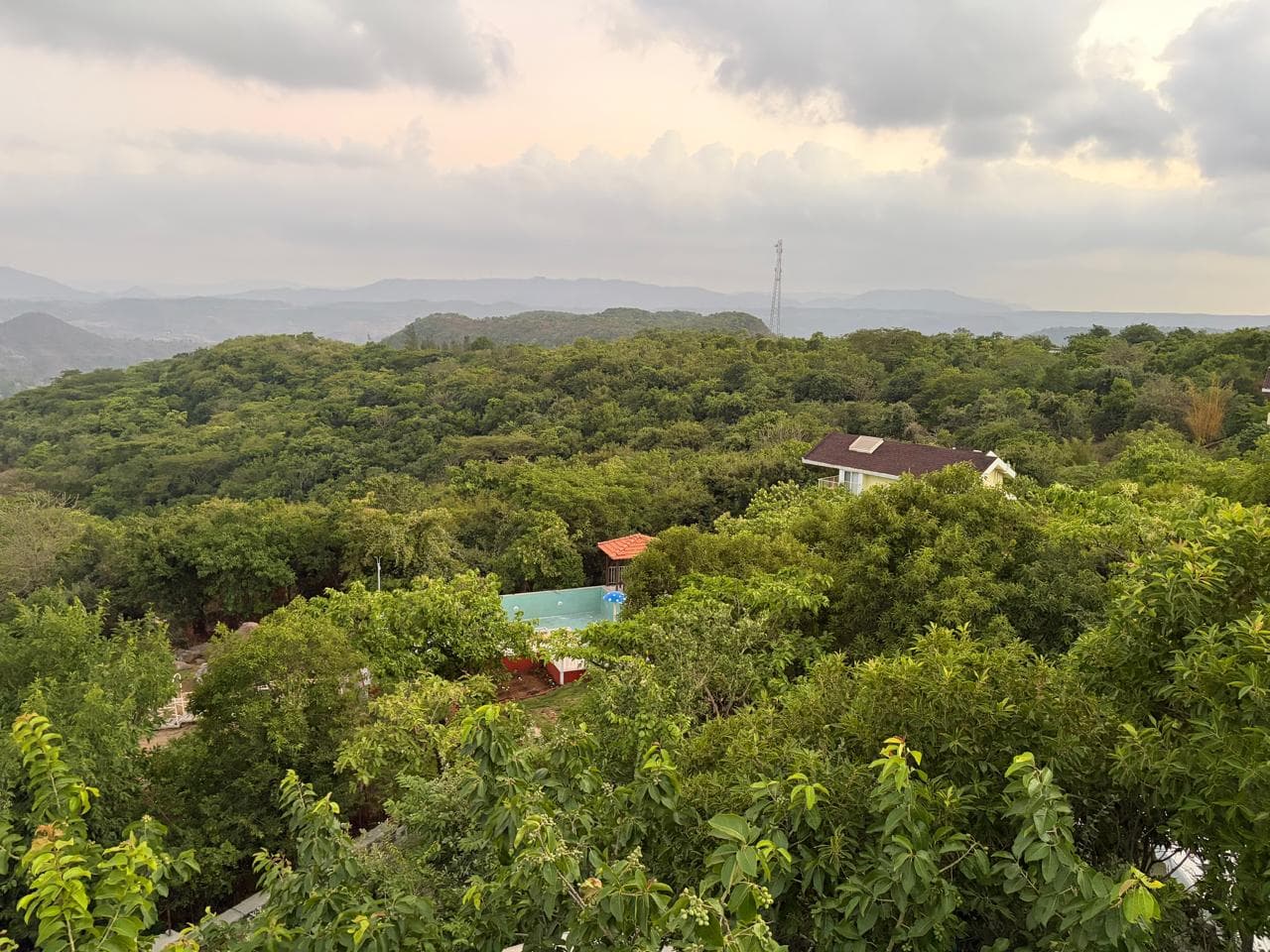 Sahyadri valley and pool view from Eshi Resorts at sunset